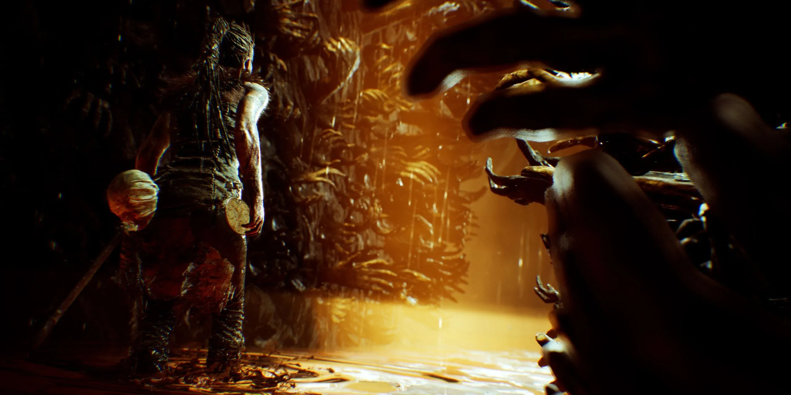 Senua and a wall of hands in Hellblade: Senua